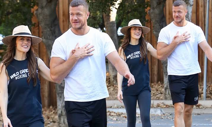 Here’s a paraphrased version:  “Imagine Dragons’ Frontman Dan Reynolds Flaunts Chiseled Physique Alongside Minka Kelly During LA Outing”